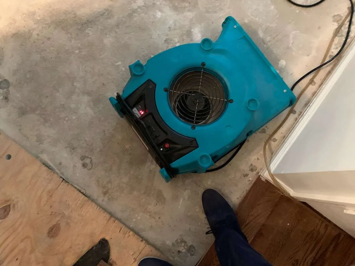 Air mover drying subfloor during Leak Detection & Repair in Long Lake